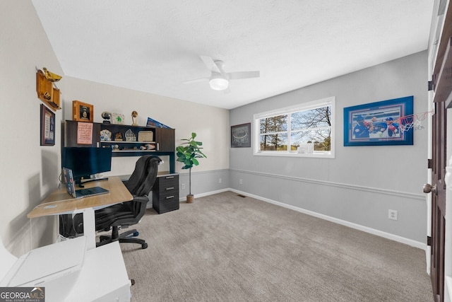 office space featuring baseboards, light carpet, a textured ceiling, and ceiling fan