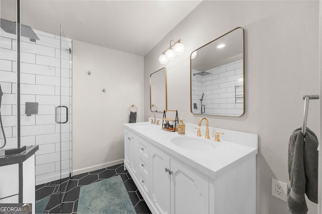 full bathroom featuring a shower stall, double vanity, tile patterned floors, and a sink