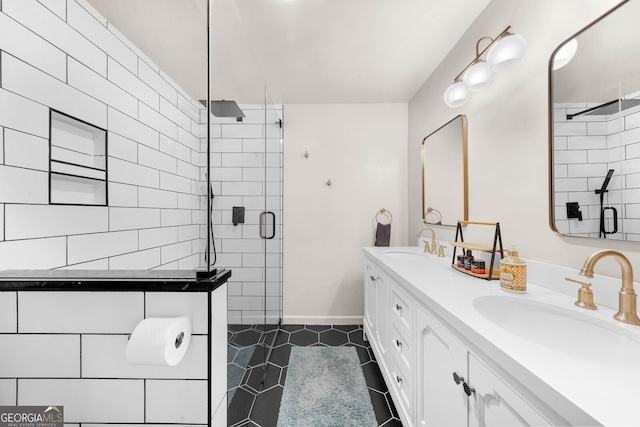 full bathroom with tile patterned floors, a stall shower, and a sink