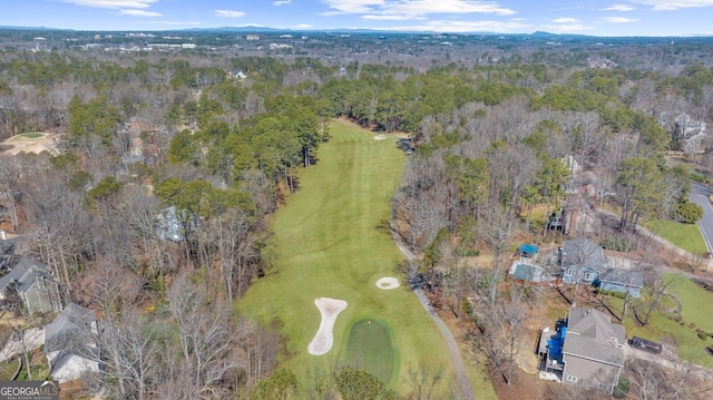 birds eye view of property featuring a view of trees