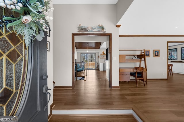 foyer with wood finished floors and baseboards