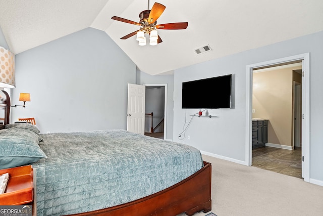 carpeted bedroom with visible vents, ceiling fan, baseboards, lofted ceiling, and ensuite bathroom