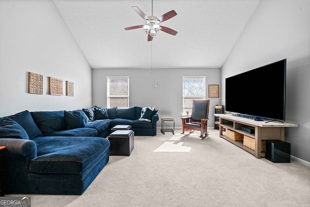 living room featuring vaulted ceiling, carpet, and a wealth of natural light