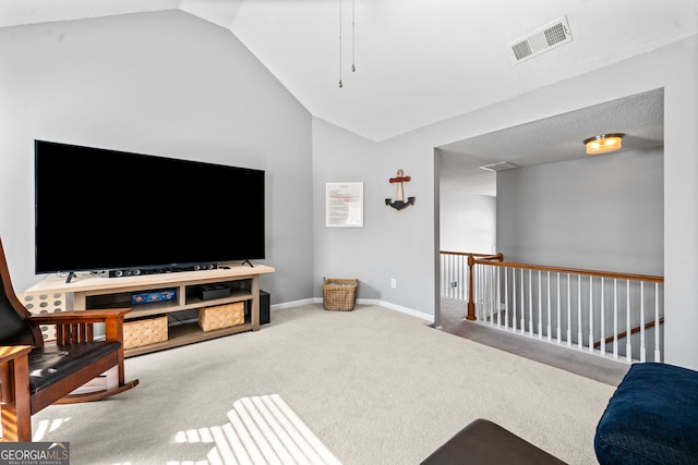 carpeted living room with visible vents, baseboards, and vaulted ceiling