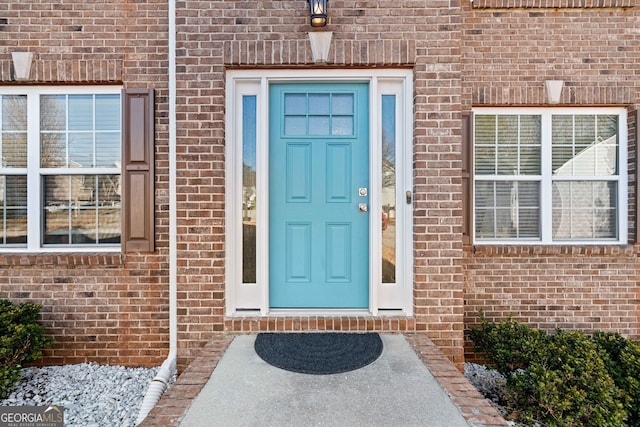 entrance to property with brick siding
