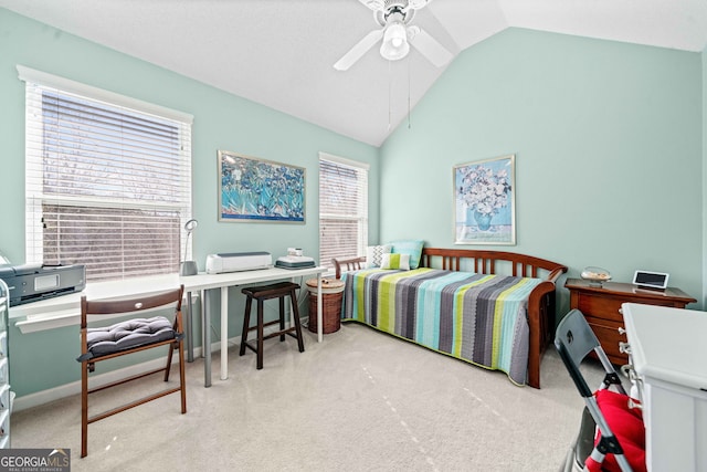carpeted bedroom with vaulted ceiling and ceiling fan