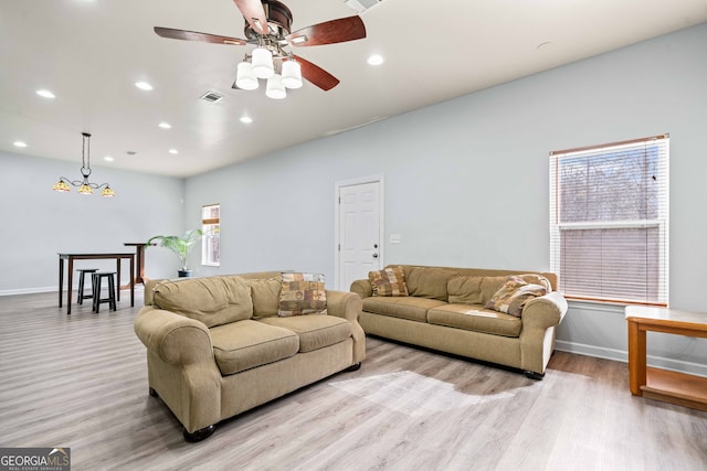 living room featuring visible vents, baseboards, recessed lighting, light wood-style floors, and a ceiling fan