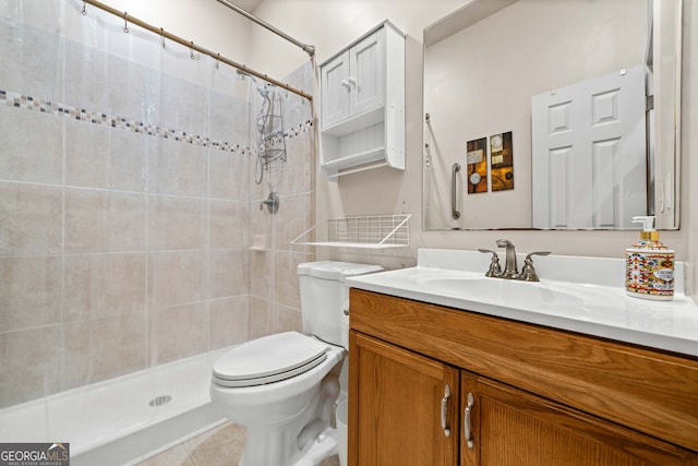 full bathroom with tile patterned floors, tiled shower, toilet, and vanity