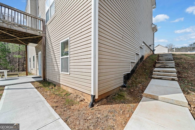 view of property exterior featuring a wooden deck