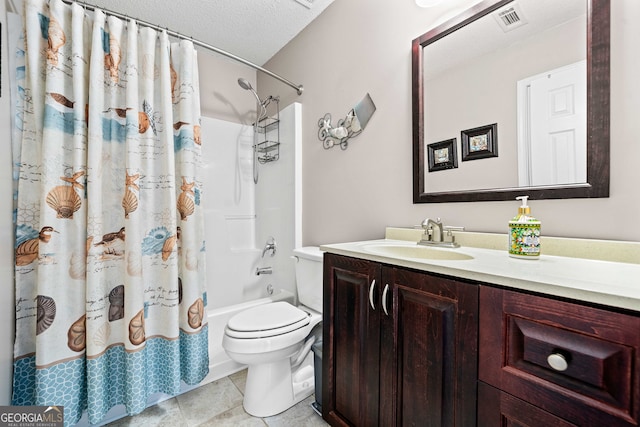 bathroom with tile patterned flooring, visible vents, toilet, vanity, and a textured ceiling
