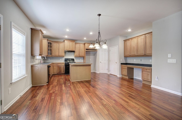 kitchen featuring a center island, glass insert cabinets, dark wood finished floors, black appliances, and a sink