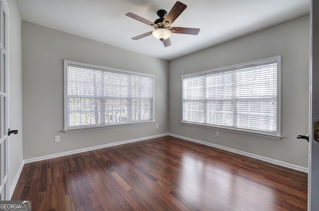 spare room with wood finished floors, baseboards, and ceiling fan