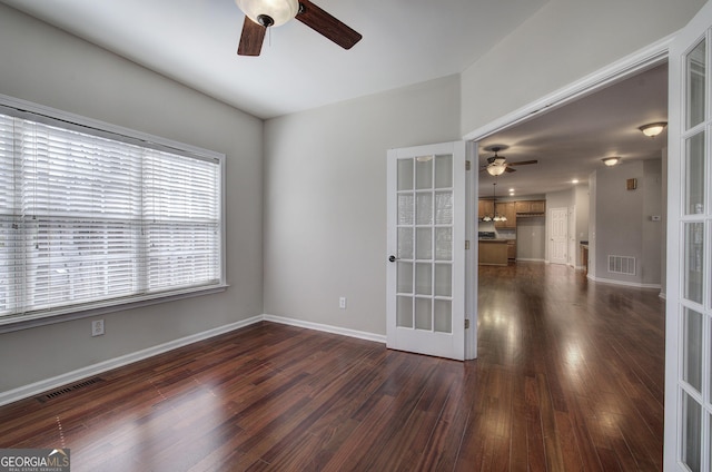 unfurnished room featuring dark wood-style floors, french doors, visible vents, and ceiling fan