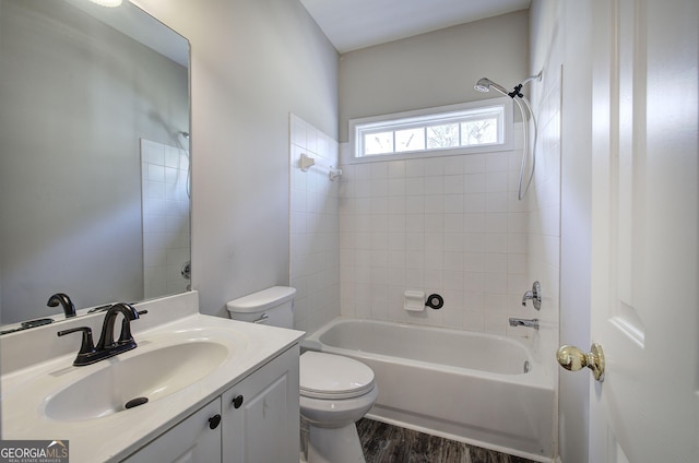 full bath with bathtub / shower combination, vanity, toilet, and wood finished floors