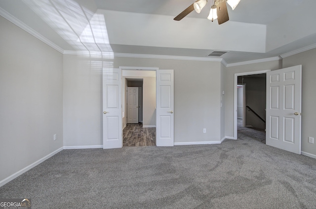 unfurnished bedroom with visible vents, carpet floors, baseboards, and ornamental molding