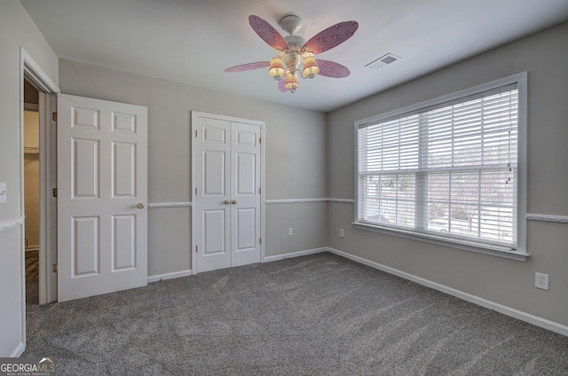 unfurnished bedroom featuring a closet, visible vents, baseboards, and carpet floors