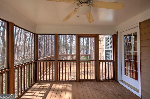 unfurnished sunroom with ceiling fan