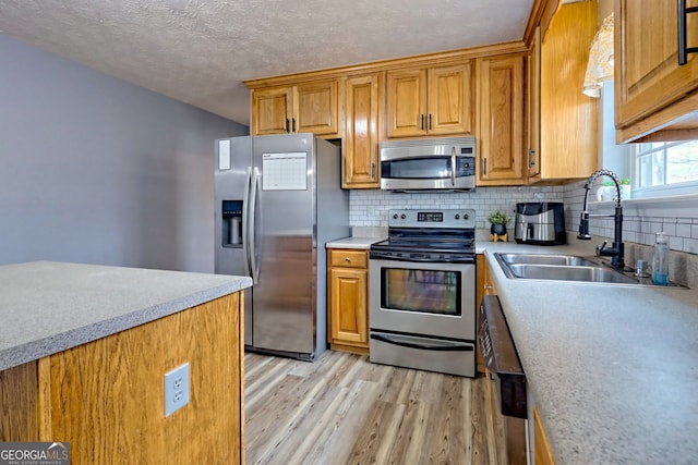 95 Volunteer Ln, Murphy, NC 28906 - kitchen with appliances with stainless steel finishes, light wood-style floors, light countertops, tasteful backsplash, and brown cabinetry