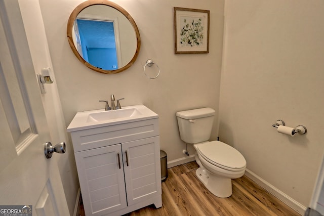 95 Volunteer Ln, Murphy, NC 28906 - half bath featuring toilet, vanity, baseboards, and wood finished floors
