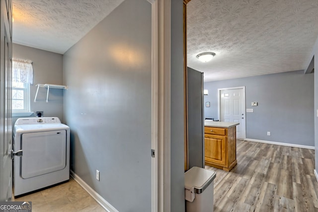 95 Volunteer Ln, Murphy, NC 28906 - washroom featuring light wood-style flooring, a textured ceiling, baseboards, washer / dryer, and laundry area