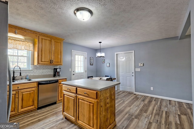 95 Volunteer Ln, Murphy, NC 28906 - kitchen featuring a sink, light wood-style floors, stainless steel dishwasher, and backsplash