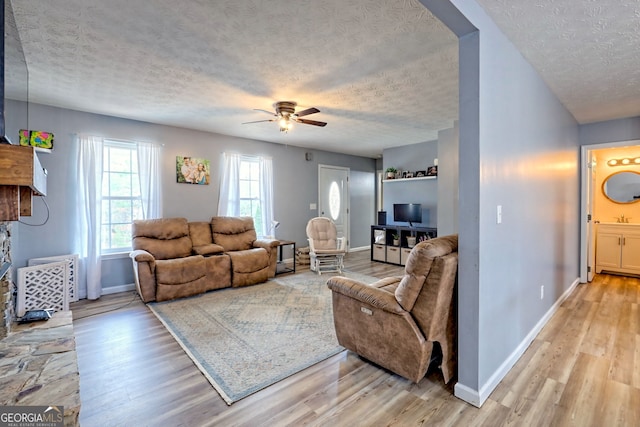 95 Volunteer Ln, Murphy, NC 28906 - living room featuring ceiling fan, baseboards, light wood-type flooring, and a textured ceiling