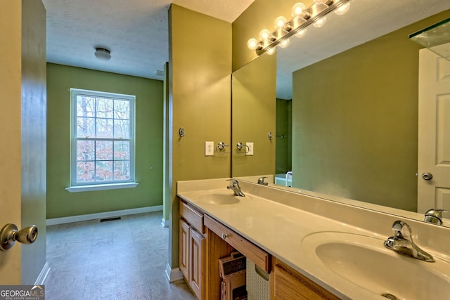 95 Volunteer Ln, Murphy, NC 28906 - bathroom with a textured ceiling, baseboards, visible vents, and a sink