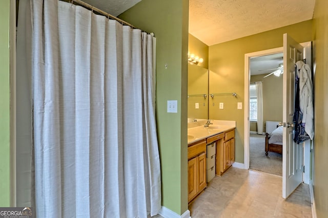 95 Volunteer Ln, Murphy, NC 28906 - bathroom with baseboards, double vanity, a sink, ensuite bathroom, and a textured ceiling