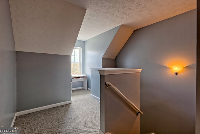 95 Volunteer Ln, Murphy, NC 28906 - corridor with baseboards, carpet floors, vaulted ceiling, a textured ceiling, and an upstairs landing