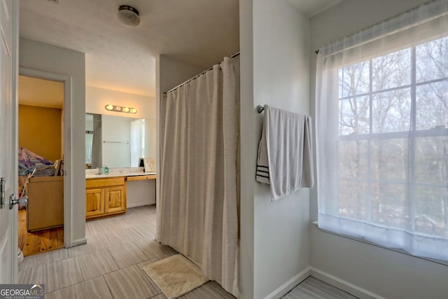 95 Volunteer Ln, Murphy, NC 28906 - full bath with curtained shower, vanity, and baseboards
