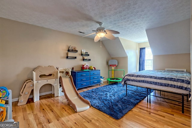 95 Volunteer Ln, Murphy, NC 28906 - bedroom featuring baseboards, visible vents, light wood-style flooring, vaulted ceiling, and a textured ceiling