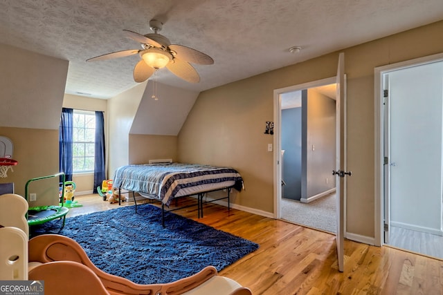 95 Volunteer Ln, Murphy, NC 28906 - bedroom with lofted ceiling, a textured ceiling, wood finished floors, baseboards, and ceiling fan