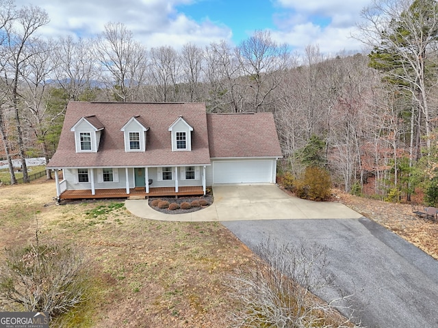 95 Volunteer Ln, Murphy, NC 28906 - new england style home featuring a porch, asphalt driveway, an attached garage, and a wooded view