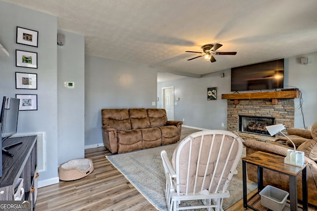95 Volunteer Ln, Murphy, NC 28906 - living area featuring baseboards, a ceiling fan, wood finished floors, and a fireplace