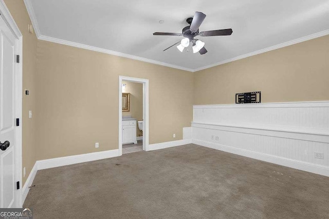 unfurnished bedroom featuring ornamental molding, a ceiling fan, ensuite bath, carpet flooring, and baseboards