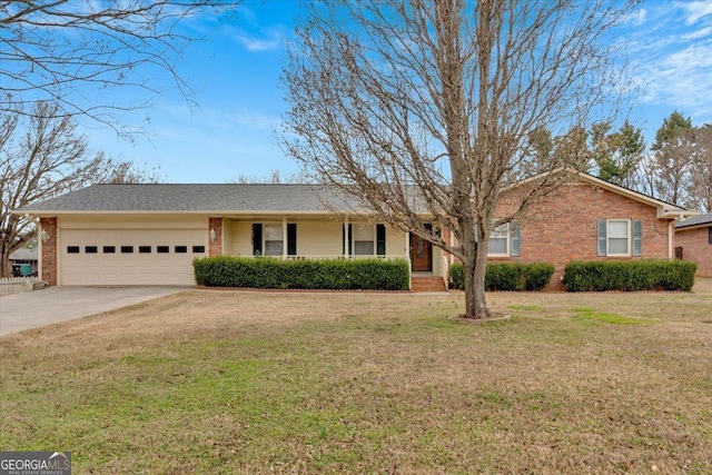 ranch-style house featuring brick siding, driveway, an attached garage, and a front lawn