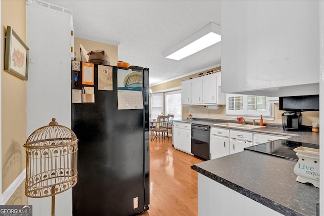 25 Wesley Trce SE, Cartersville, GA 30120 - kitchen with white cabinetry, black appliances, light wood-style flooring, and a sink