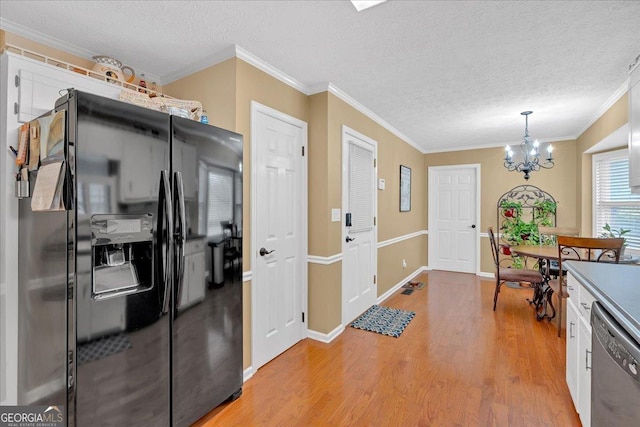 25 Wesley Trce SE, Cartersville, GA 30120 - kitchen with light wood finished floors, ornamental molding, a textured ceiling, stainless steel dishwasher, and black refrigerator with ice dispenser