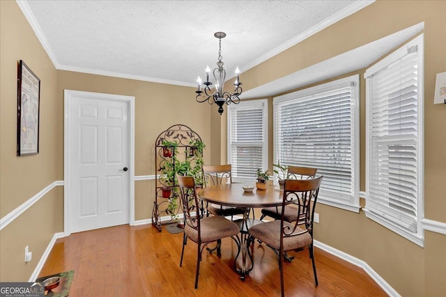 25 Wesley Trce SE, Cartersville, GA 30120 - dining room featuring a notable chandelier, a textured ceiling, light wood-style floors, crown molding, and baseboards