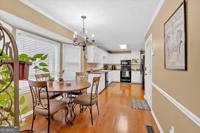 25 Wesley Trce SE, Cartersville, GA 30120 - dining area with visible vents, an inviting chandelier, crown molding, and light wood-style floors