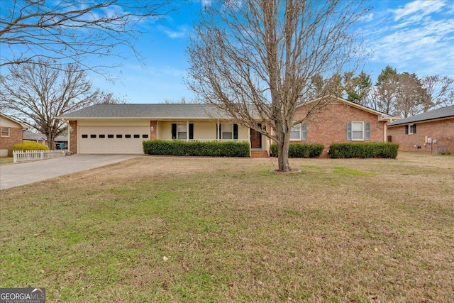 ranch-style home with brick siding, a front lawn, fence, a garage, and driveway