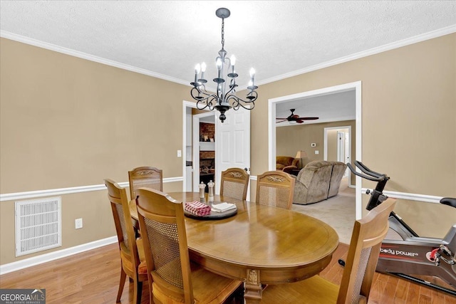 25 Wesley Trce SE, Cartersville, GA 30120 - dining room with visible vents, a textured ceiling, light wood-style flooring, and ornamental molding