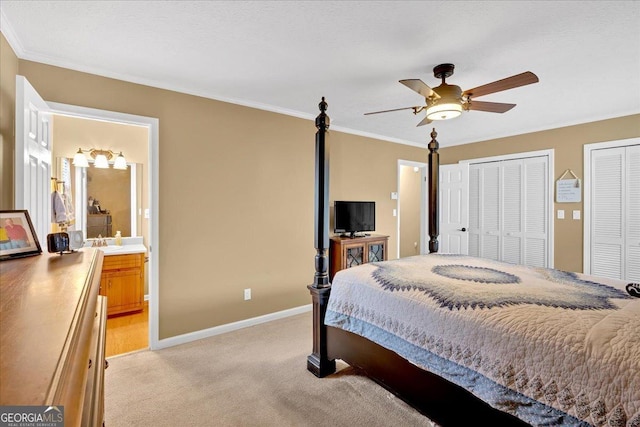 25 Wesley Trce SE, Cartersville, GA 30120 - bedroom with multiple closets, ornamental molding, a sink, baseboards, and light colored carpet