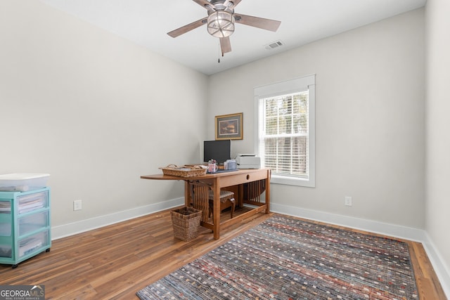 office featuring wood finished floors, visible vents, and baseboards