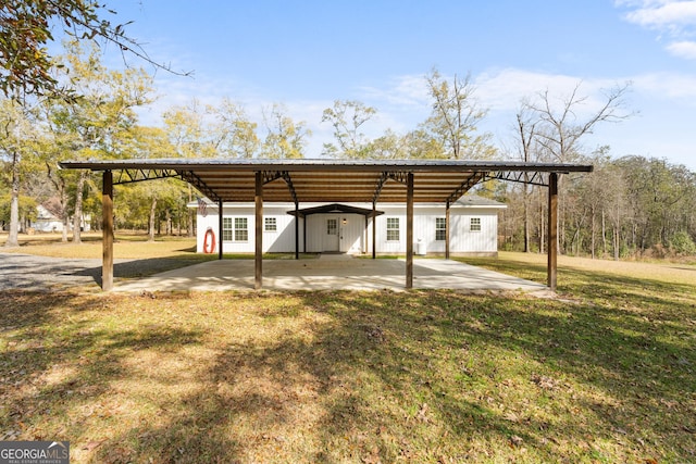 view of parking / parking lot featuring a carport and driveway