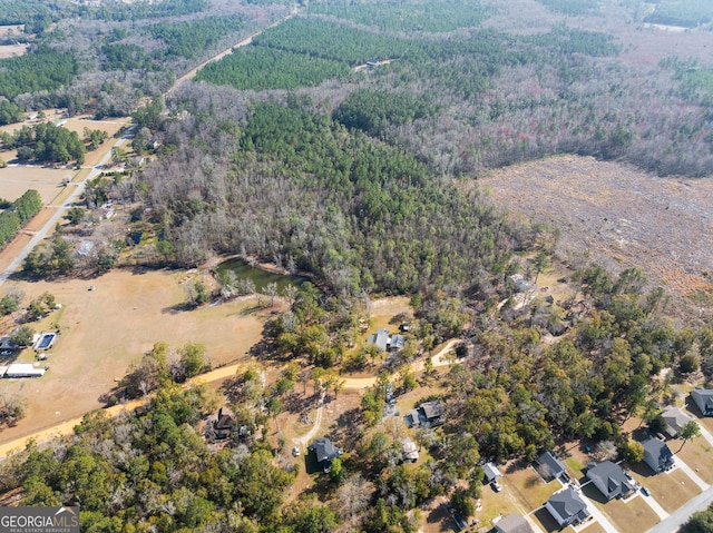 birds eye view of property featuring a forest view