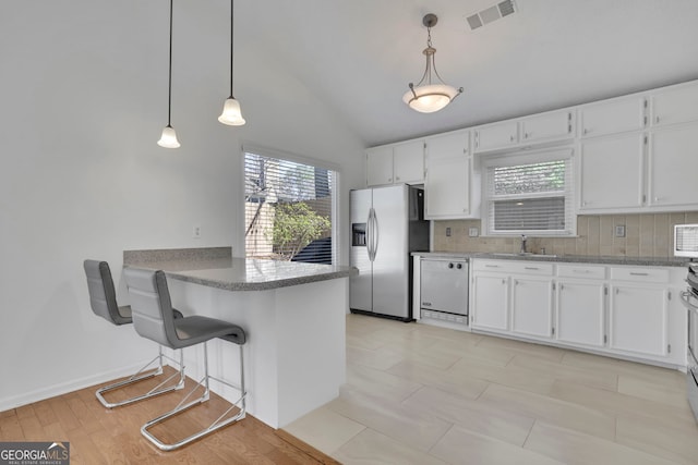 kitchen featuring visible vents, stainless steel fridge, tasteful backsplash, and dishwasher