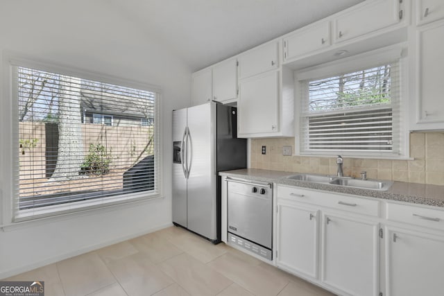 kitchen with a healthy amount of sunlight, white cabinets, stainless steel appliances, and a sink