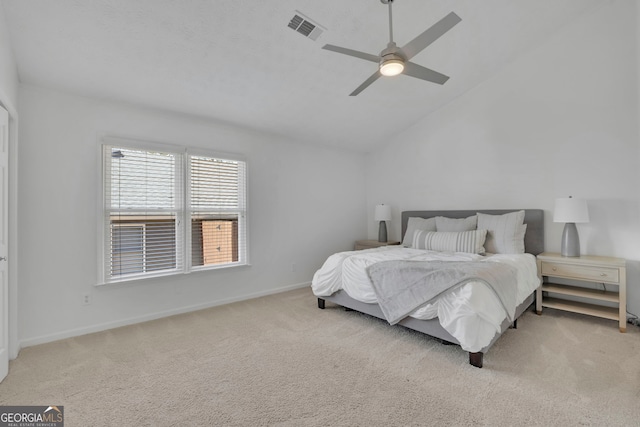 bedroom featuring visible vents, a ceiling fan, baseboards, carpet flooring, and lofted ceiling