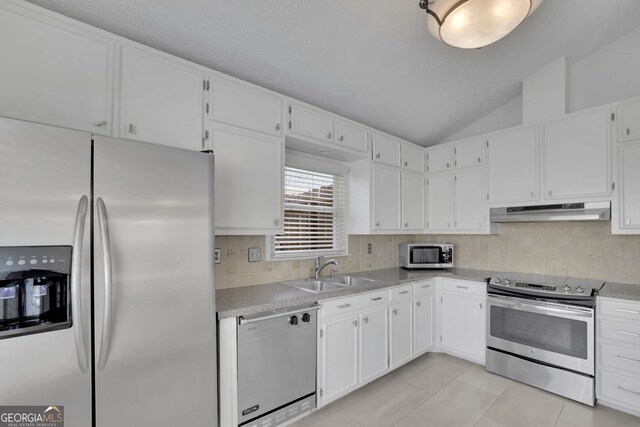 kitchen with under cabinet range hood, stainless steel appliances, white cabinets, and a sink